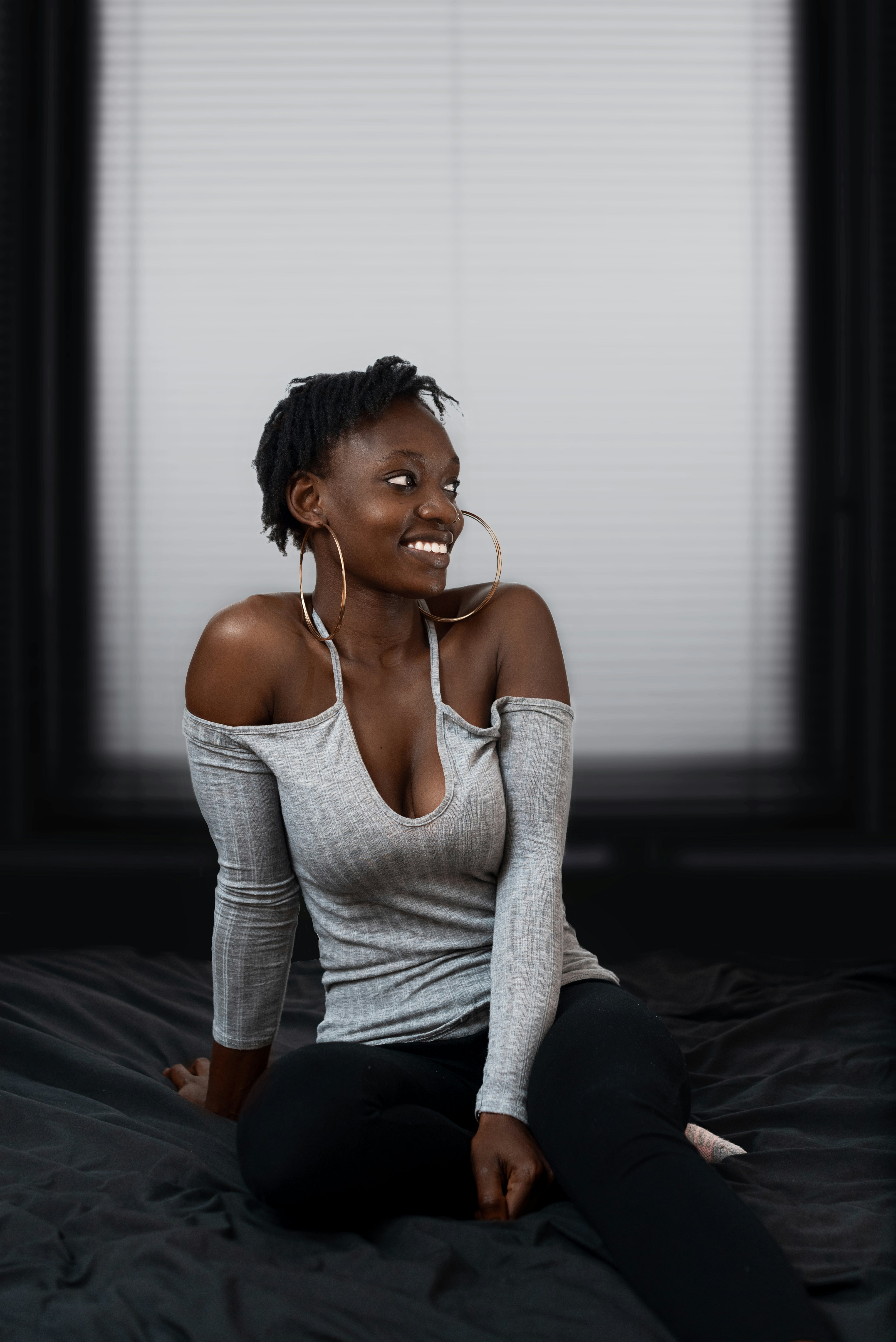 woman in white long sleeve shirt and black pants sitting on floor